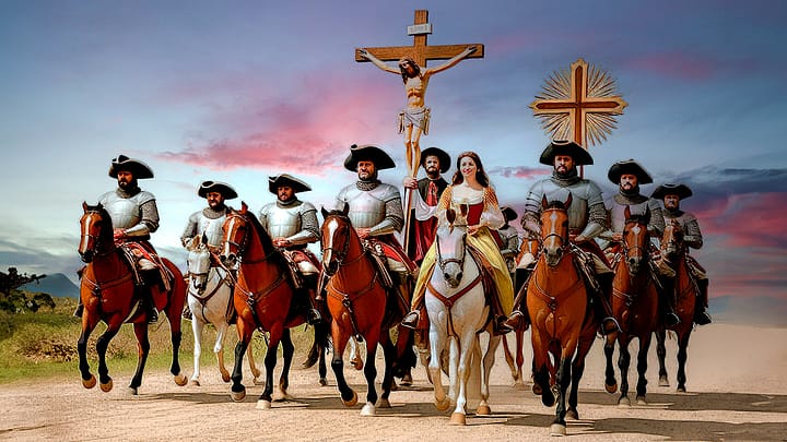 Conquistadores españoles. Imagen de un grupo de conquistadores españoles a caballo portando un gran crucifijo con Jesús.